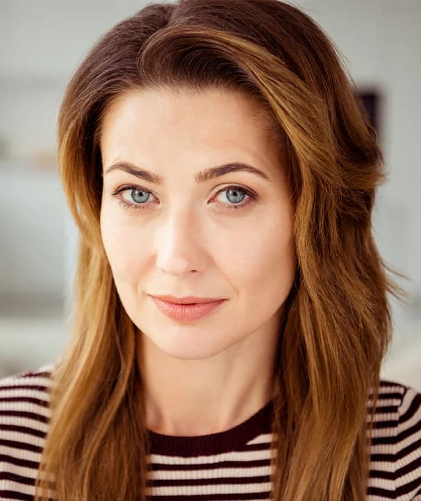 Woman with smooth natural facial contours and youthful appearance following deep plane facelift in New York