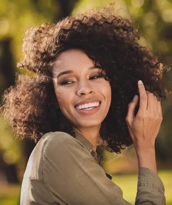 Rhinoplasty: Smiling woman with natural nasal profile and balanced facial features