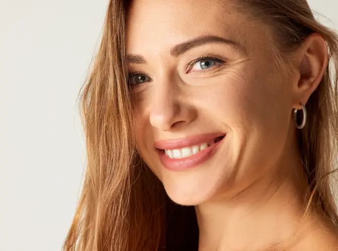 Rhinoplasty: Smiling woman showing natural nasal profile and facial balance